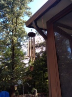 Wind chimes playing music outside the porch